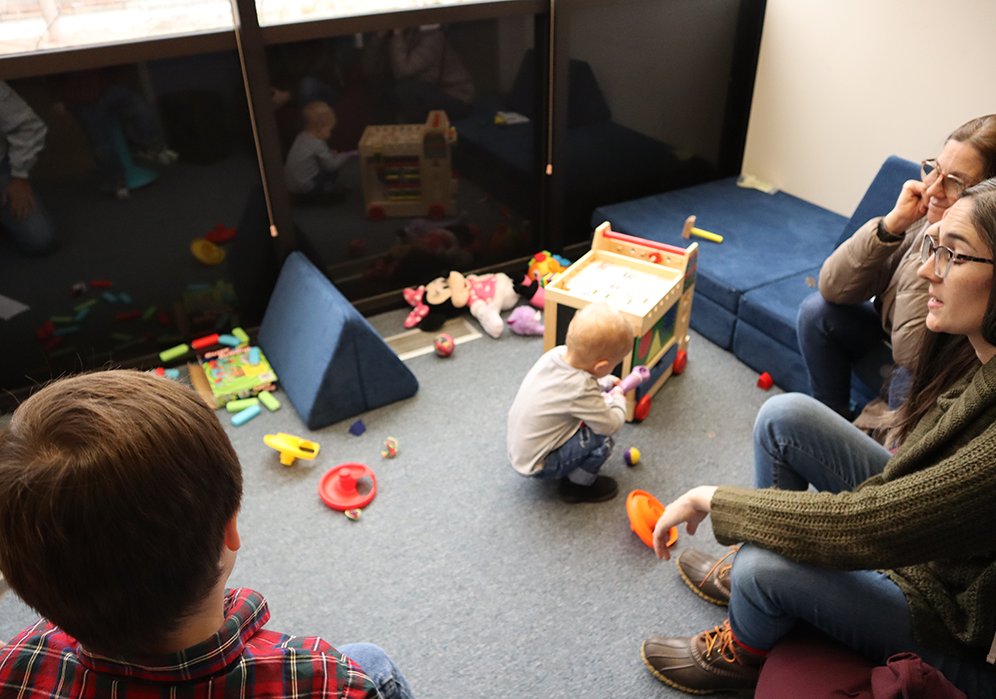 Families playing in the CEW+ student caregiver space